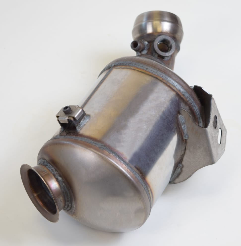 A metallic catalytic converter with welded joints and an attachment bracket is displayed against a white background.